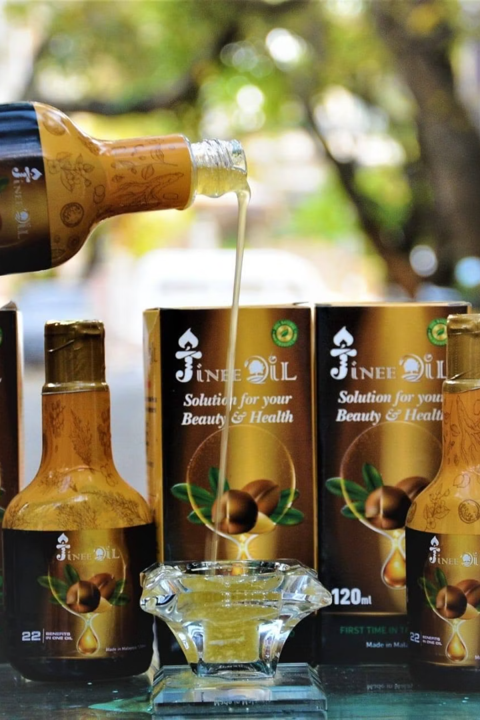 Jinee Oil being poured from the bottle into a glass dish